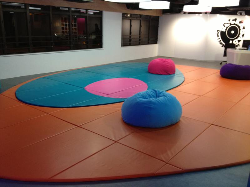 Patchwork floor mats and protective padding in an indoor activity room