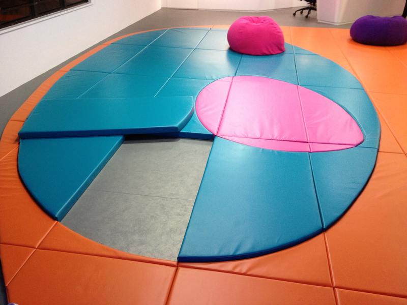 Round soft mats and cushions in an indoor activity room