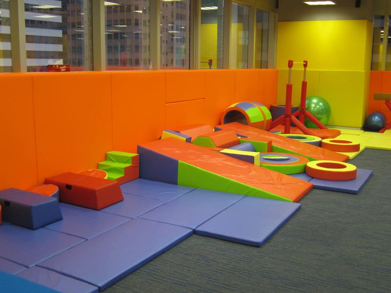 Colourful protective padding in an indoor children's activity space
